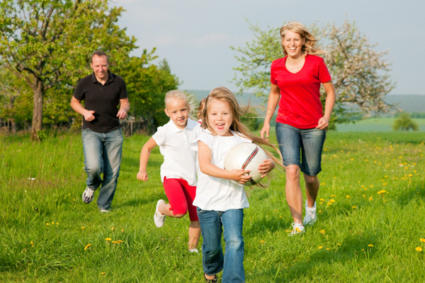 family playing ball outside