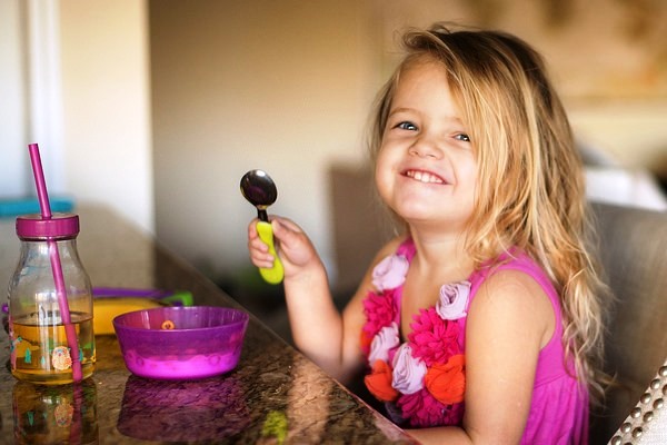 Little Girl Enjoying Her Meal