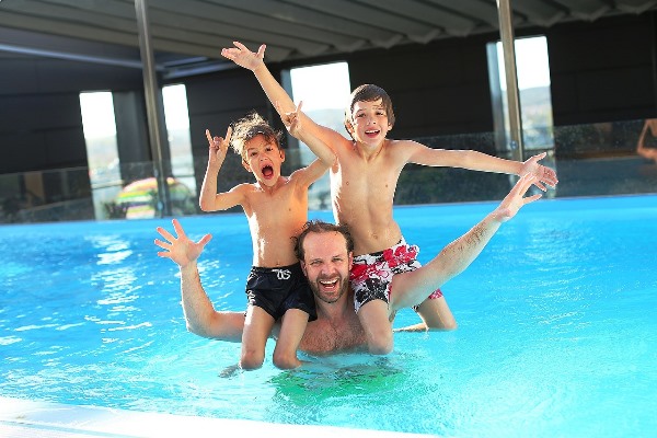 Father Swimming with his Children